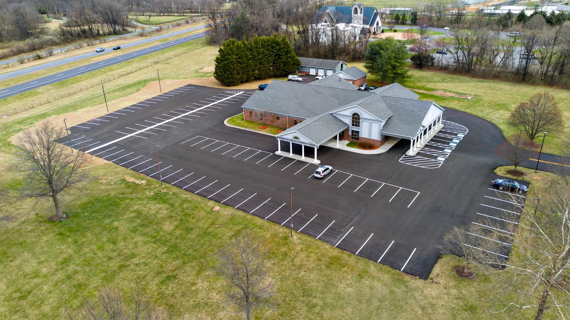 Aerial image of Shirley Funeral Home after completion of site work, paving, and concrete services.