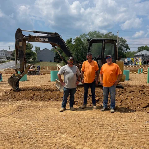 Pine Knoll Construction field crew standing together on a job site.