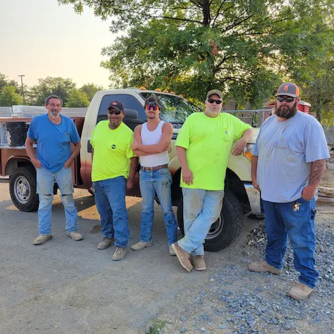 Pine Knoll Construction field crew standing together on a job site.