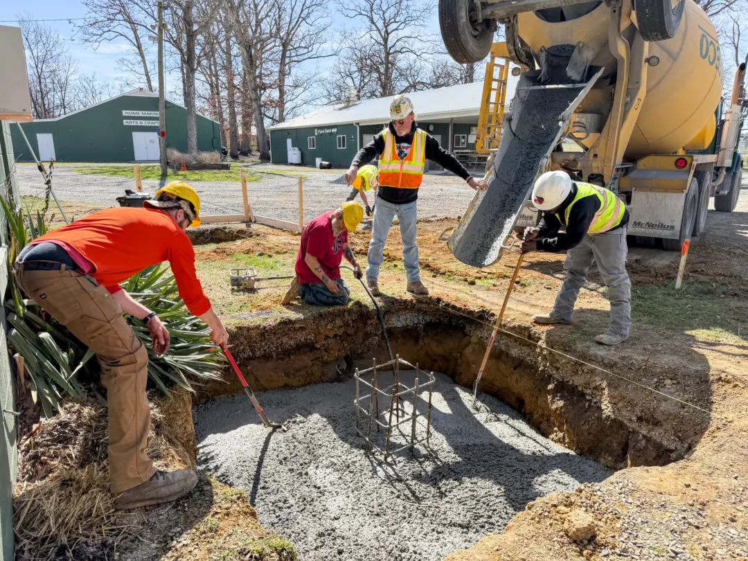 Pine Knoll Construction crew completing concrete services including poured concrete footers on a site work project.