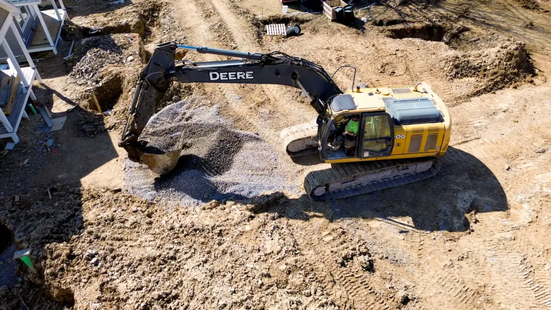 Aerial photo of Excavator digging gravel on a site work project.