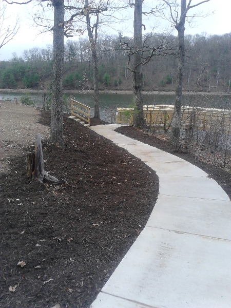 Concrete walkway leading to the lake holiday fishing pier installed by Pine knoll construction