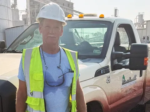 Stacy Herring standing in front of a Pine Knoll Truck.